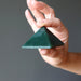 hand holding dark green aventurine pyramid
