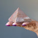 hand holding pink aventurine pyramid