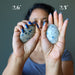 sheila of satin crystals holding two azurite palm stones in her hands to show size difference