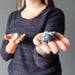 woman holding out azurite tumbled stones