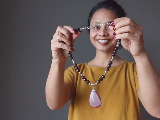 video on female wearing mookaite jasper and red garnet beaded necklace