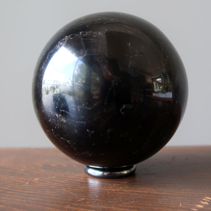 black tourmaline sphere on hematine ring stand