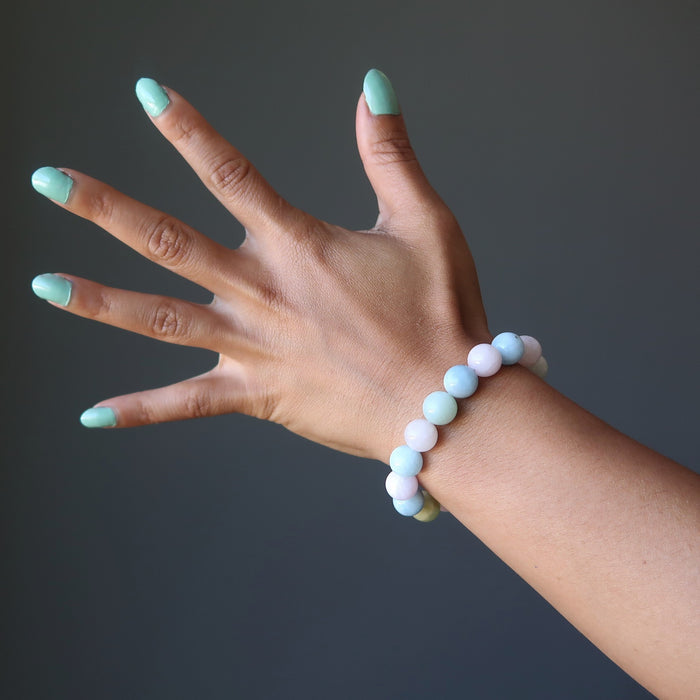 woman's hand wearing multicolored beryl beaded stretch bracelet