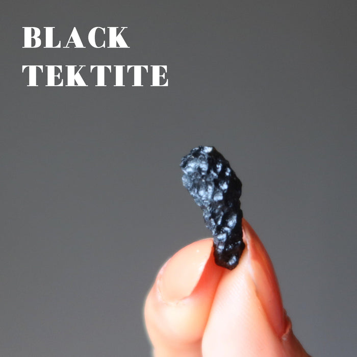 finger tips holding a Black Tektite 