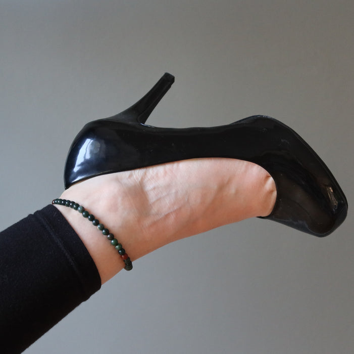 woman in high heels wearing bloodstone anklets