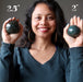 sheila of satin crystals holding two bloodstone spheres in her palms to show size difference