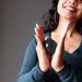 sheila of satin crystals holding an indian bloodstone sphere at the heart chakra
