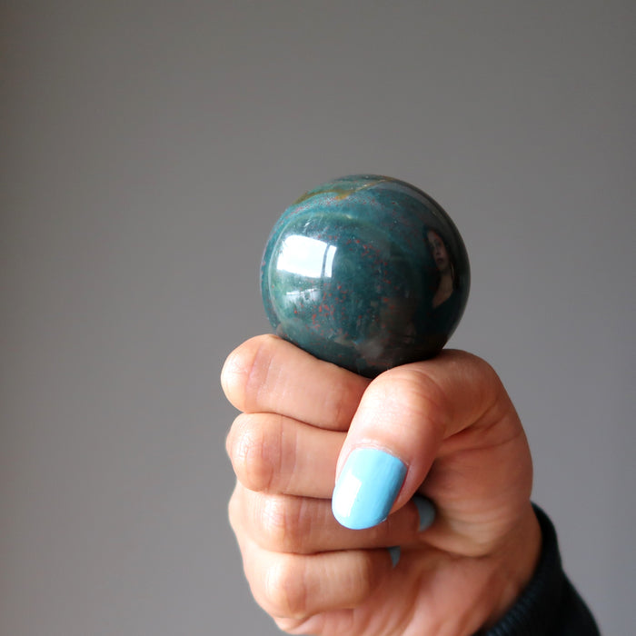 fist holding an indian bloodstone sphere