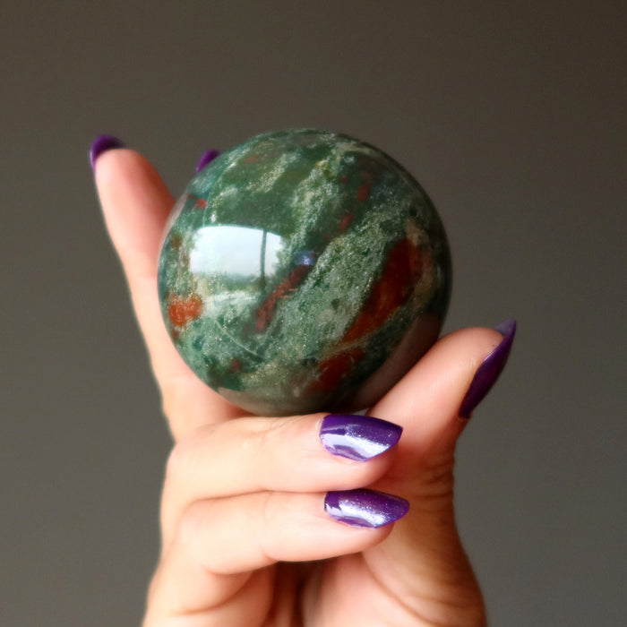 hand holding indian bloodstone sphere