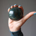 hand holding A bloodstone crystal sphere