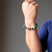 female arm  wearing bloodstone bracelets