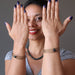 sheila of satin crystals with hands up wearing bloodstone coil bracelets on each wrist