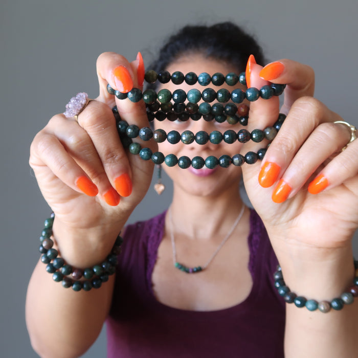 sheila of satin crystals holding faceted bloodstone bracelets