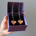 brown wood heart shaped world map charms on dark green bloodstone beaded earrings and antiqued steel earwire in purple gift box