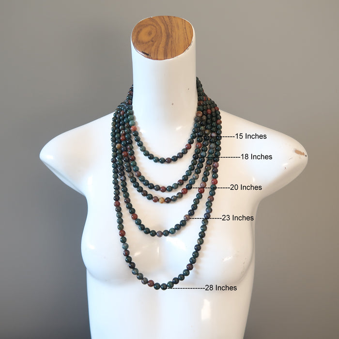mannequin layered with female wearing bloodstone necklace in different lengths