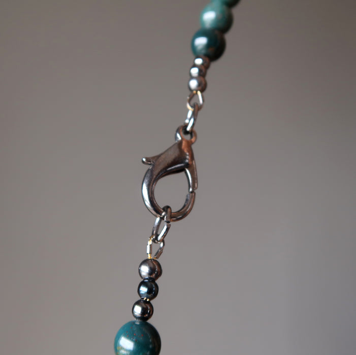 lobster claw clasp of howlite and bloodstone beaded necklace