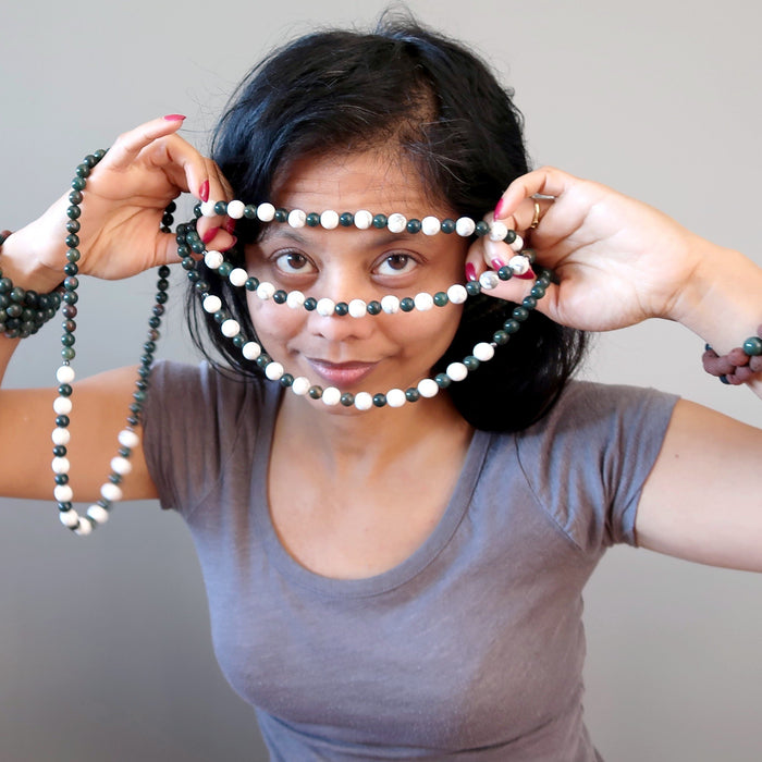 sheila of satin crystals holding howlite and bloodstone beaded necklaces