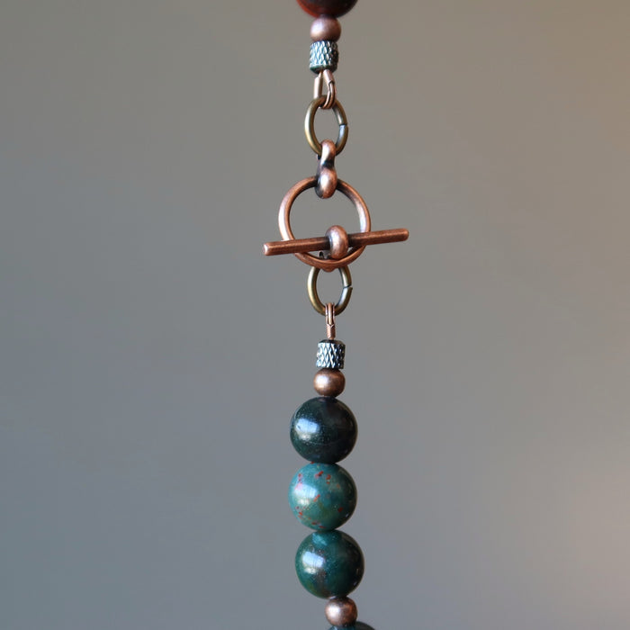 showing the brass toggle clasp of bloodstone necklace