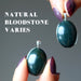 two bloodstone pendants to show stones vary