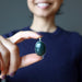 hand holding indian bloodstone pendant in front of chest