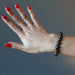 hand wearing a bronzite bracelet