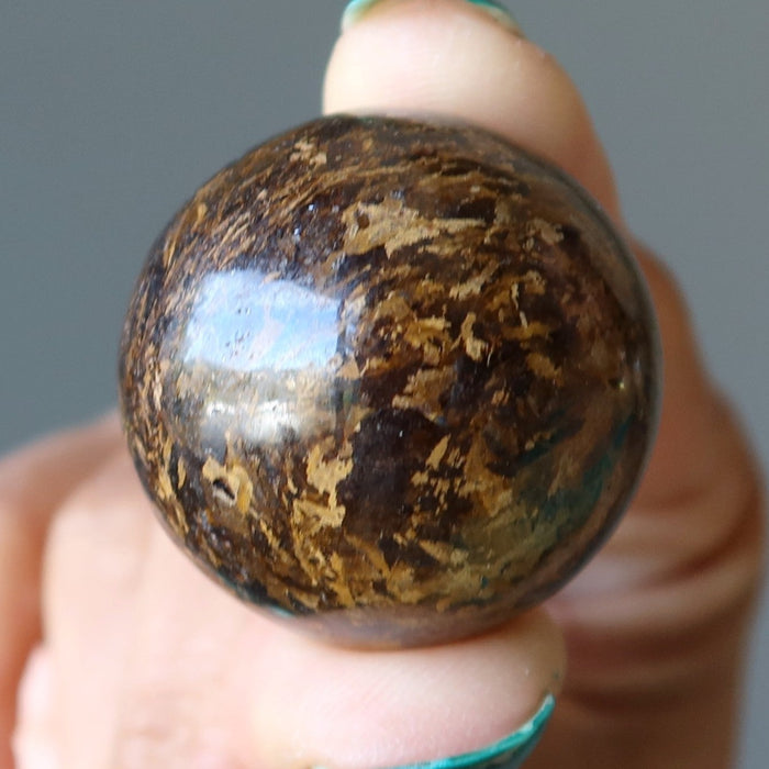 holding Bronzite Sphere
