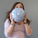 female model holding extra large blue calcite sphere