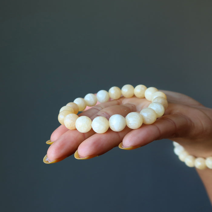 Yellow Calcite round beaded Bracelet on the model palm