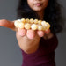 sheila of satin crystals holding a yellow calcite beaded stretch bracelet