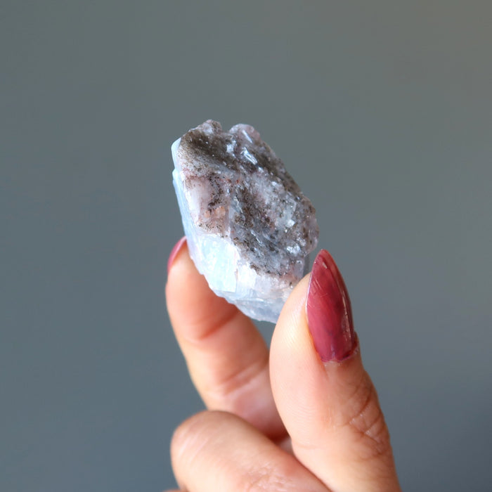 holding a Blue Calcite Raw Gemstone 