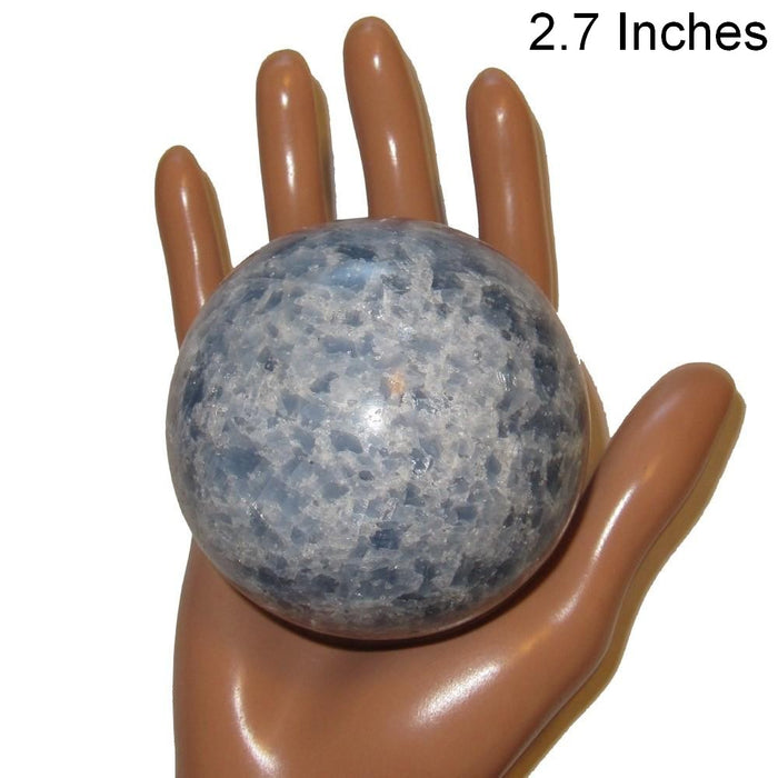 blue calcite sphere in model hand