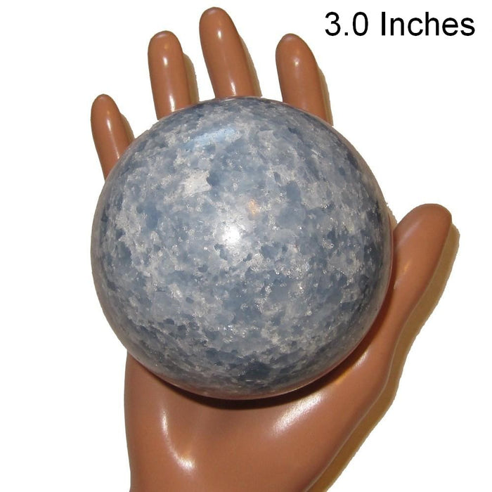 blue calcite sphere in model hand