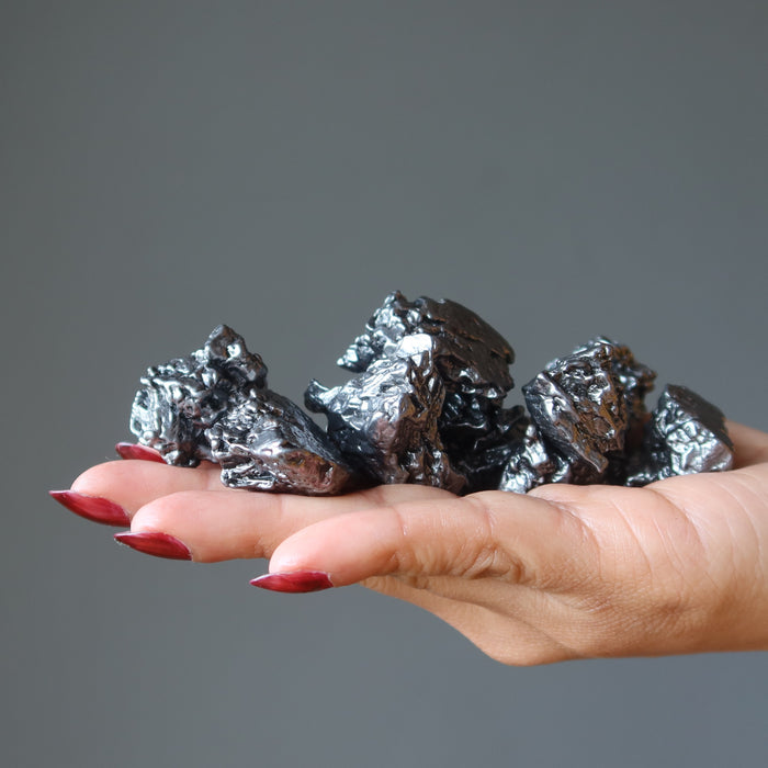 holding few Campo Del Cielo Meteorite on the palm