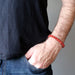 male hand model wearing carnelian bracelets