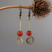 orange carnelian on spiral dangle earrings hanging from branch