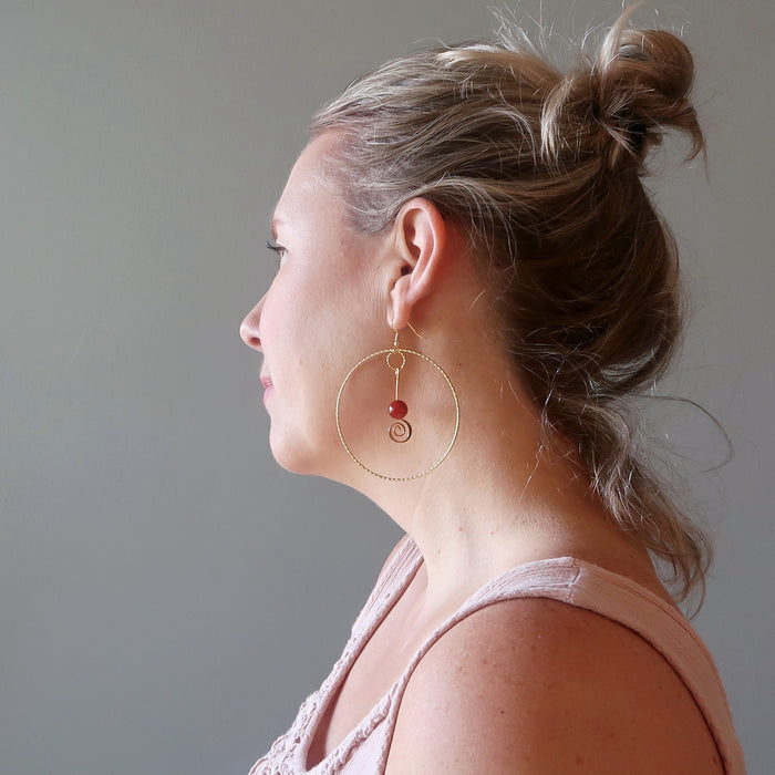 woman wearing carnelian hoop earrings