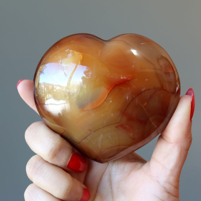 holding orange carnelian heart