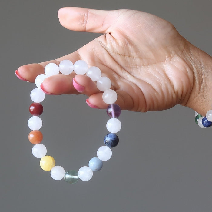 hand holding snow white quartz chakra bracelets