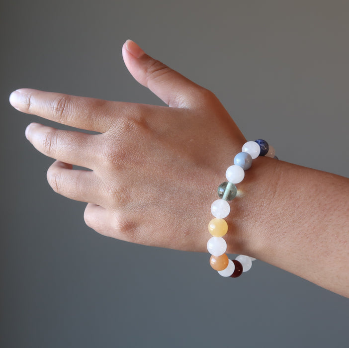 hand wearing snow white quartz chakra bracelets