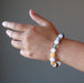 hand wearing snow white quartz chakra bracelets