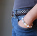 hand in jeans pocket wearing snow white quartz chakra bracelets