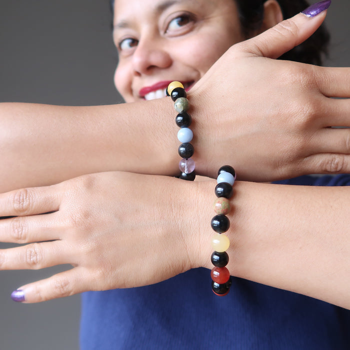 sheila of satin crystals wearing 2 rainbow obsidian and natural chakra stone stretch bracelets