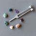 7 chakra stones and tuning fork set with amethyst, apatite, amazonite, emeral, citrine, sunstone, ruby