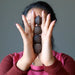 sheila of satin crystals holding four Brown Raw Chalcedony Gemstones 