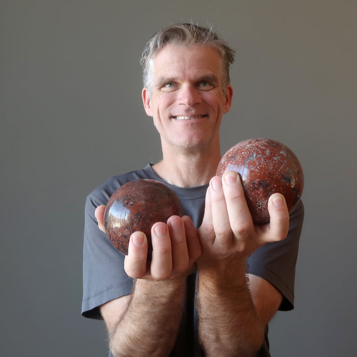 ryan of satin crystals holding two chalcedony spheres