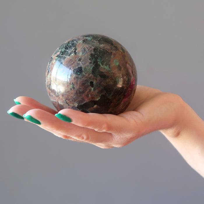 hand holding chalcocite sphere