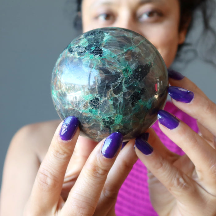 sheila of satin crystals gazing into a chalcocite sphere