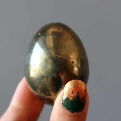 hand holding chalcopyrite egg