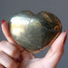 hand holding gold Chalcopyrite Heart 