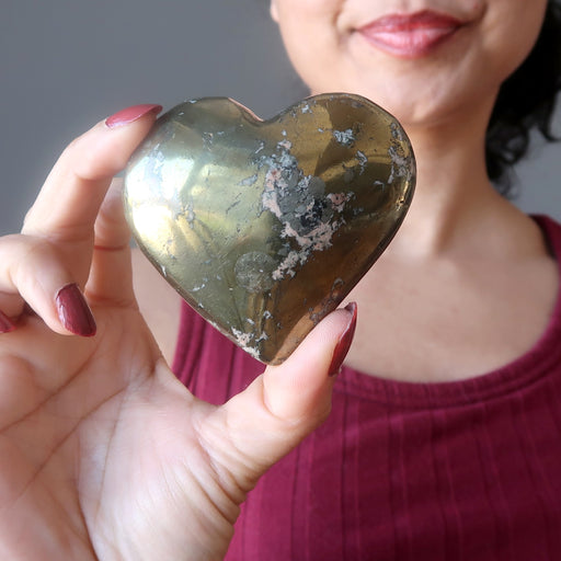 sheila of satin crystals holding Gold Pink Chalcopyrite Heart